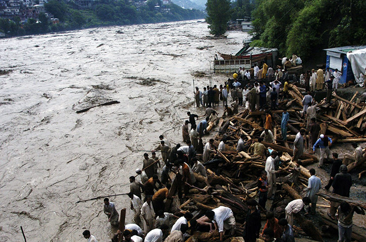 Pakistan floods: Pakistani residents watch the flood water in Muzaffarabad 
