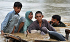Local residents scramble to safety in a flood-hit area of Nowshera, Pakistan