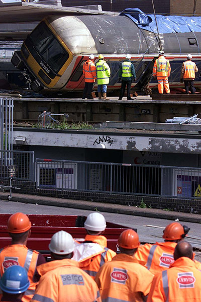Potters Bar train crash: Railway workers watch removal of railway carriage from Potters Bar station