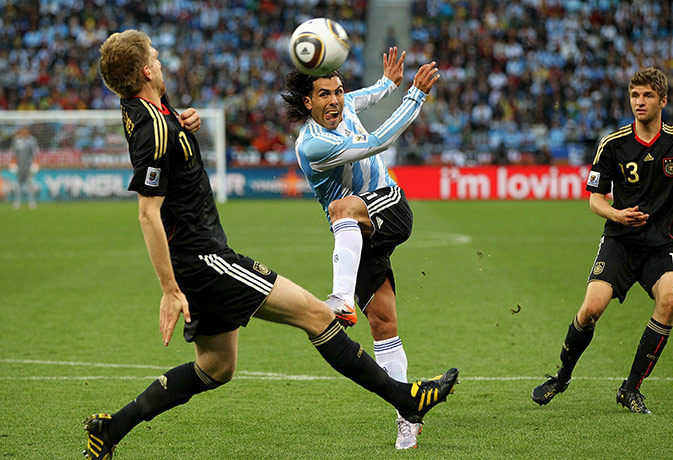 World Cup Quarter-Finals: Carlos Tevez shoots but it hits Mertesacker in the face