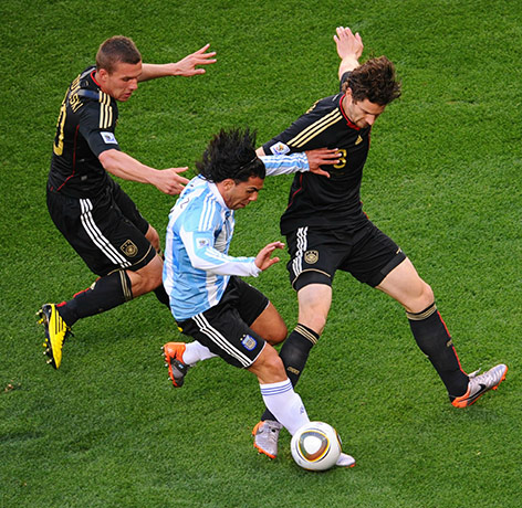 World Cup Quarter-Finals: Carlos Tevez, Arne Friedrich, right, and Lukas Podolski