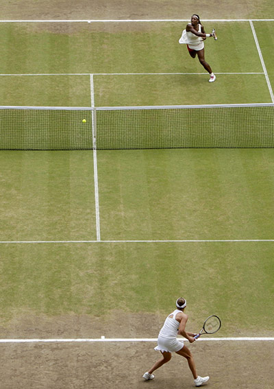 Serena wins wimbledon: Serena Williams hits a forehand return to Vera Zvonareva 