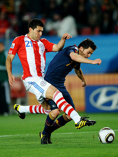 Paraguay versus spain: Penalty. David Villa goes down under the challenge of Antolin Alcaraz