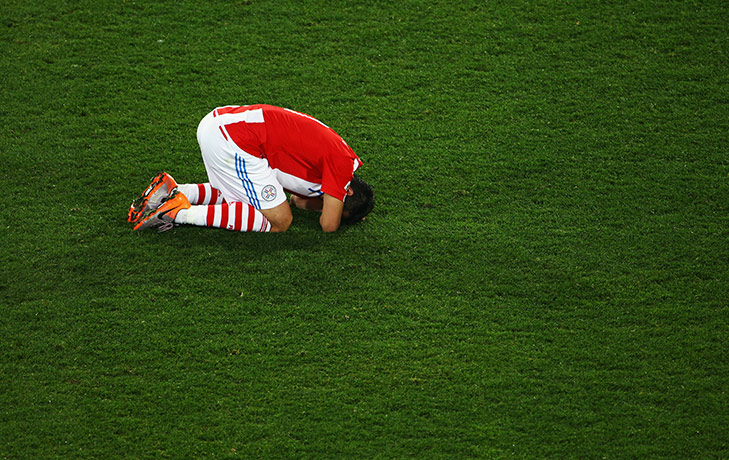 Paraguay versus spain: Oscar Cardozo is dejected after the final whistle