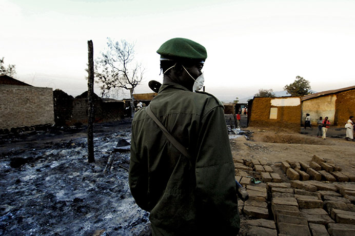 Congo tanker explosion: A Congolese soldier stands guard at the site of an oil tanker explosion