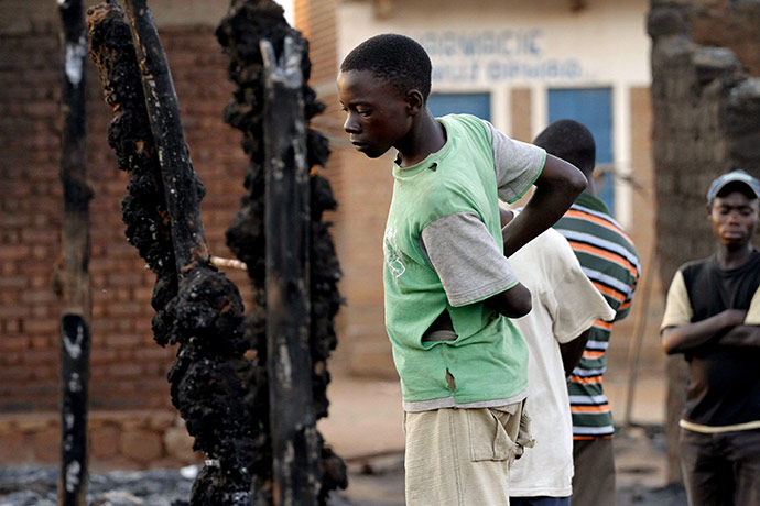 Congo tanker explosion: A boy inspects the aftermath of oil tanker explosion in Sange