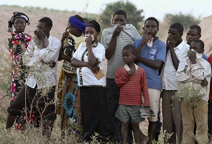 Congo tanker explosion: Residents of the town of Sange, Congo, watch a mass grave