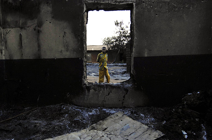 Congo tanker explosion: A resident of the town of Sange, Congo, inspects a fire damaged building