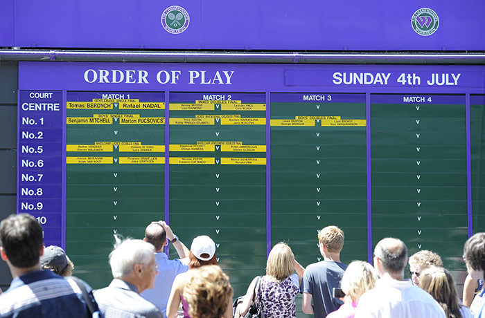 Men's singles final: Fans walk past the order of play board