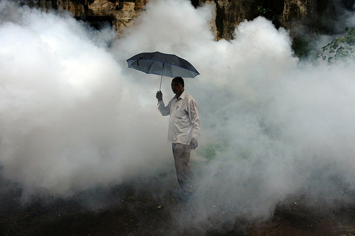 24 hours in pictures: A municipal manager oversees an anti-malaria fumigation operation in Mumbai