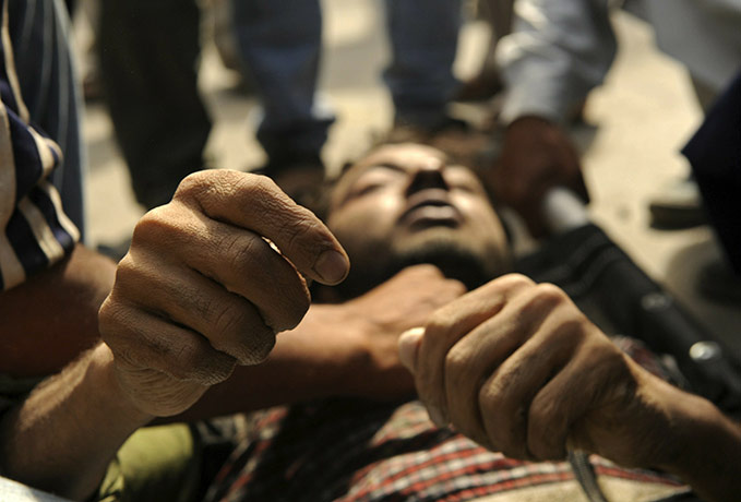 24 hours in pictures: Kashmiri mourners carry a body 