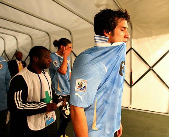 Holland versus Uruguay:  Mauricio Victorino thinks what might have been as he walks down the tunnel