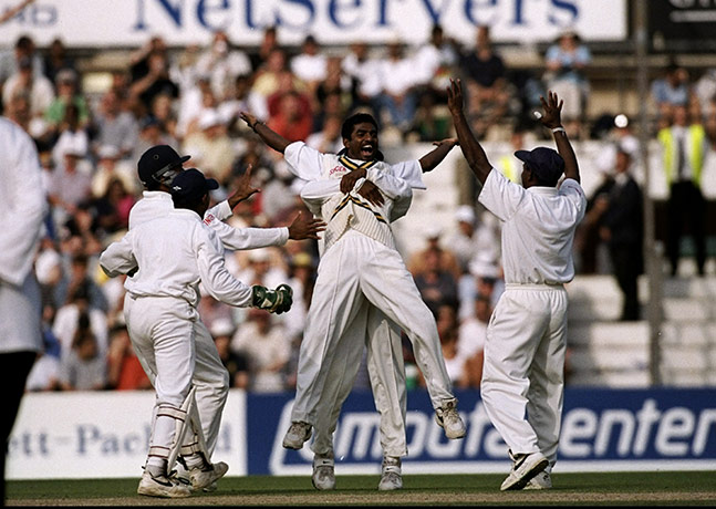 Muttiah Muralitharan: Muttiah Muralitharan is congratulated by team-mates after taking a wicket
