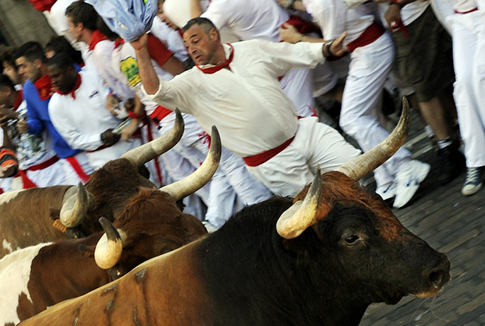 Pamplona bull running: Participants run in front of Penajaras f