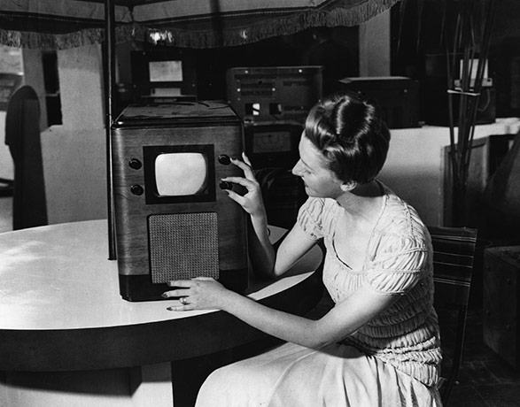 Television: 1938: A woman demonstrating a television set at a Radio Exhibition