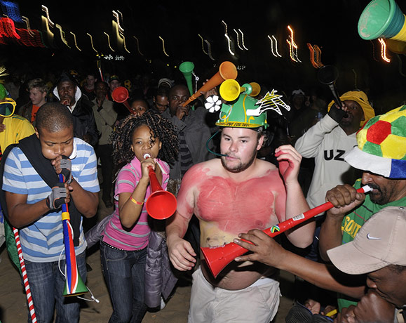 Fans' network: Football fans dancing on the beach in South Africa