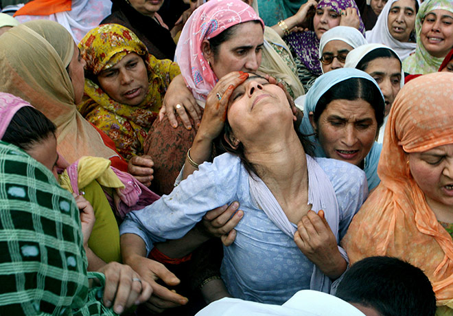 24 hours in pictures: Srinagar, India: Neighbours console a relative of Abrar Ahmad