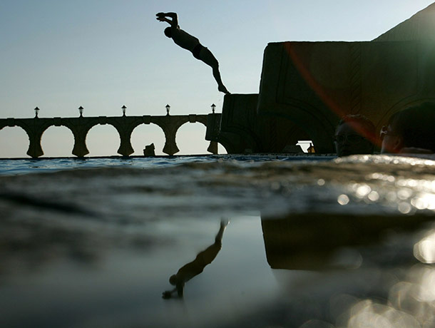 24 hours in pictures: Sochi, Russia: A man jumps in the Black Sea