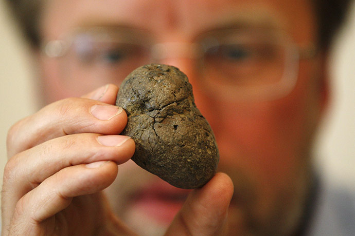 The first Britons: Simon Parfitt holds up a fossilised hyena dropping