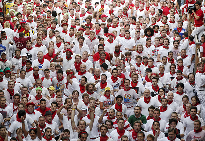 San Fermín fiesta: Hundreds of 'mozos,' or runners, walk through the streets of Pamplona