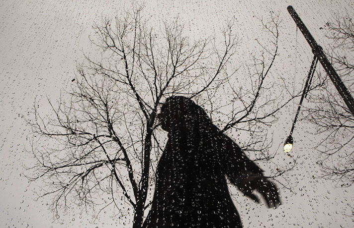 24 hours in pictures: An office worker walks by, on a rainy winter afternoon in central Sydney