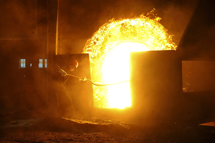 24 hours in pictures: Hefei, China: An employee works at a workshop in a steel and iron factory 