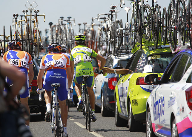 TDF stage 5: A rider takes refreshment from the team car