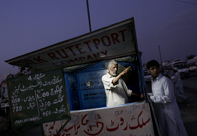 24 hours in pictures: Rawalpindi, Pakistan: A ticket salesman gives directions
