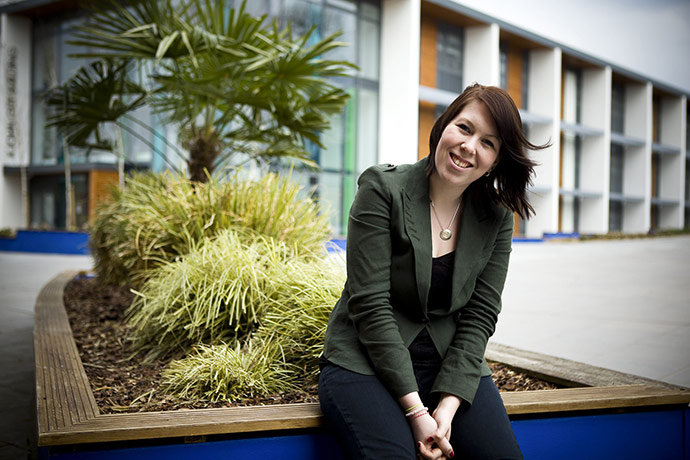 Fair Trade Town: A young woman sits in a college hallway