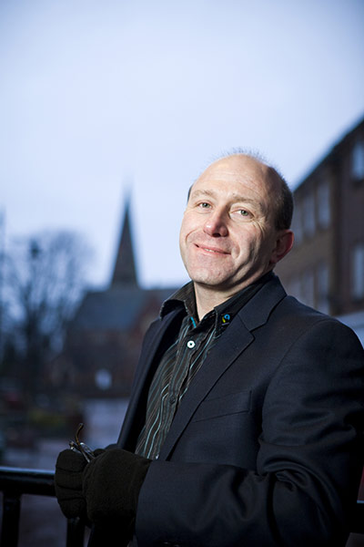 Fair Trade Town: A middle aged man stands smiling in street