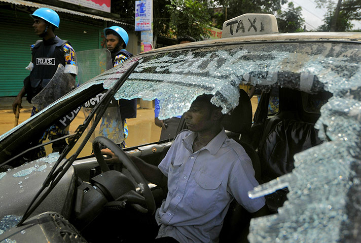 24 hours: Asulia, Bangladesh: Police surround a taxi cab whose windscreen was smashed