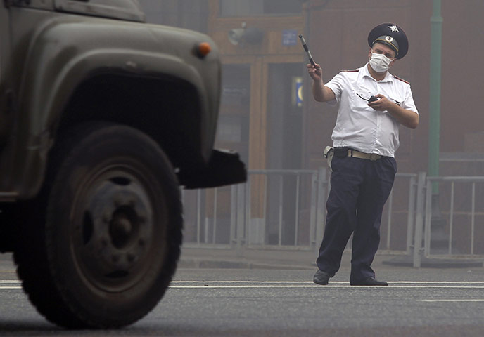 Moscow smog: A traffic controller from the Interior Ministry wears a protective mask