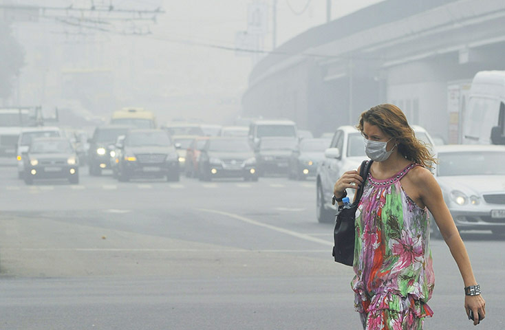 Moscow smog: A Russian woman wears a face mask while walking in central Moscow 