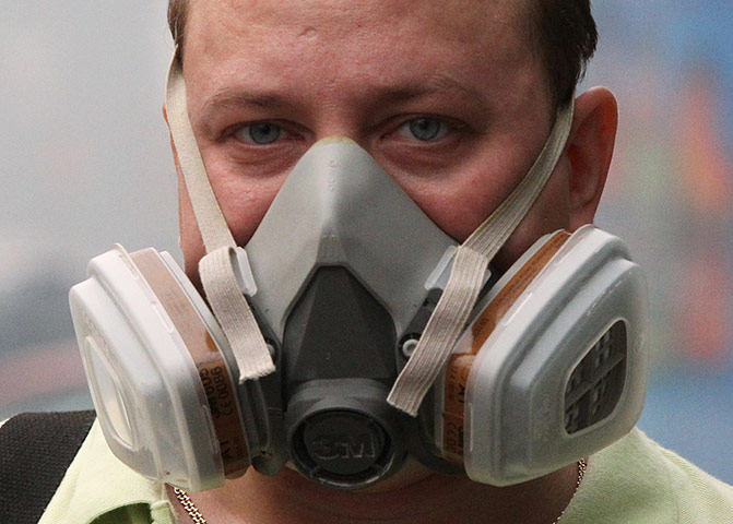 Moscow smog: A man wears a mask to protect himself from the smog in central Moscow 