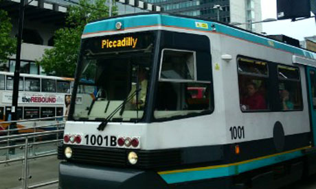 A Metrolink tram and the City tower in Manchester city centre. Photograph: Paul Owen.