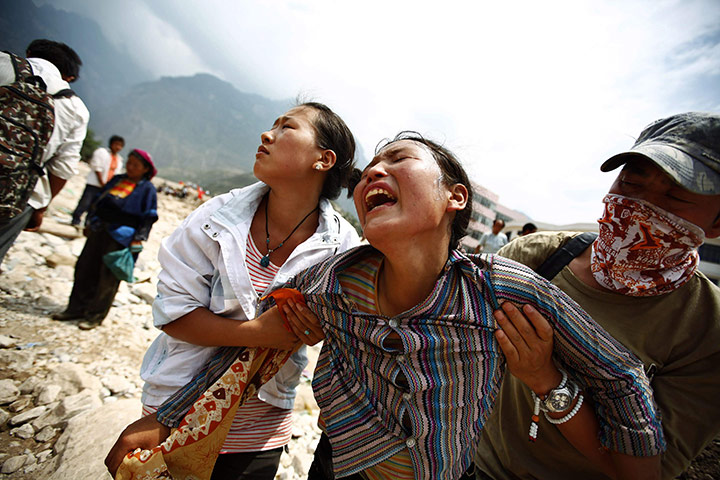 China Floods Update: A woman mourns her missing relatives in the landslide-hit Zhouqu, China