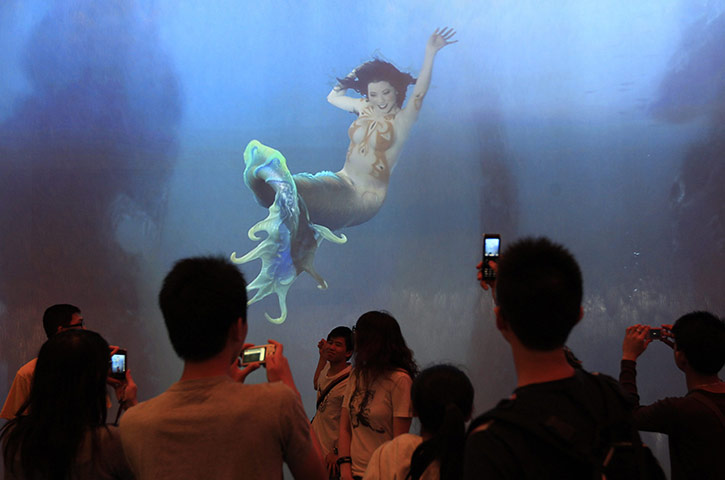 24 hours in pictures: Macau, China: Visitors take photos at the City of Dream Casino 