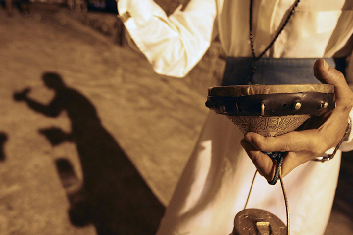 24 hours in pictures: A Musaharati strikes his drum to wake Muslims  during Ramadamn