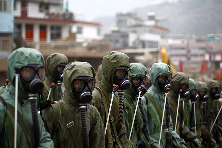 24 hours in pictures: Rescuers prepare to disinfect a landslide-hit street in Zhouqu County 