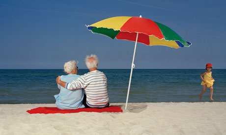 Couple Watching Child on the Beach