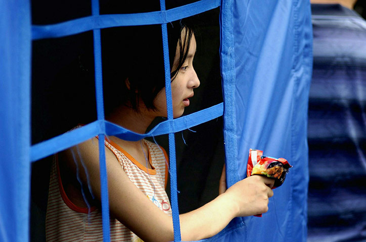 China Flood update: Child at a temporary settlement in Zhouqu