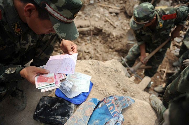 China Flood update: Chinese rescuers recover money from flooding victim, China mudslide