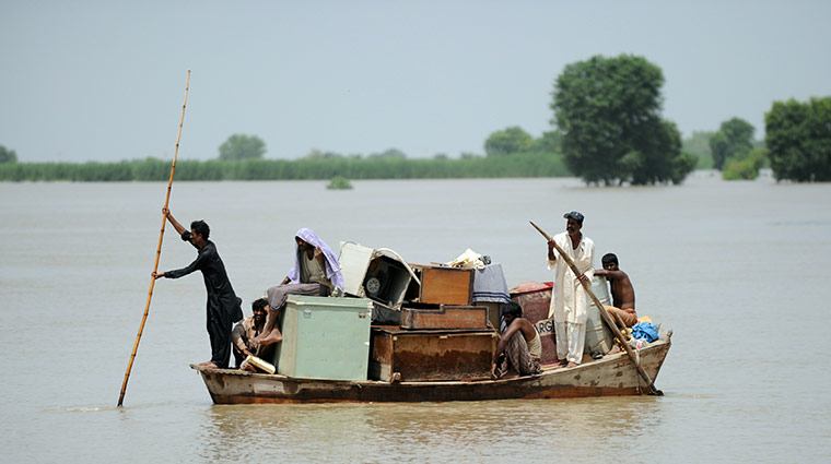 Pakistan Flood Disaster: Pakistani flood survivors use a boat to