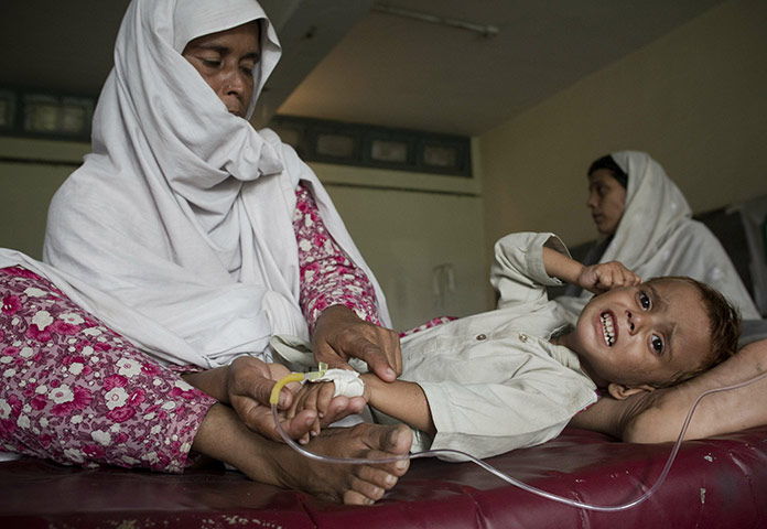 Pakistan Flood Disaster: A flood-displaced Pakistani mother cares