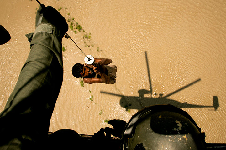 Pakistan Flood Disaster: A villager is rescued by a Pakistani navy helicopter, flood distaster