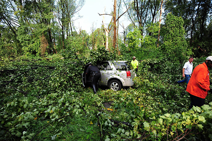 24 hours: Silver Spring, Maryland, USA: A policeman gets in a car stuck under trees 