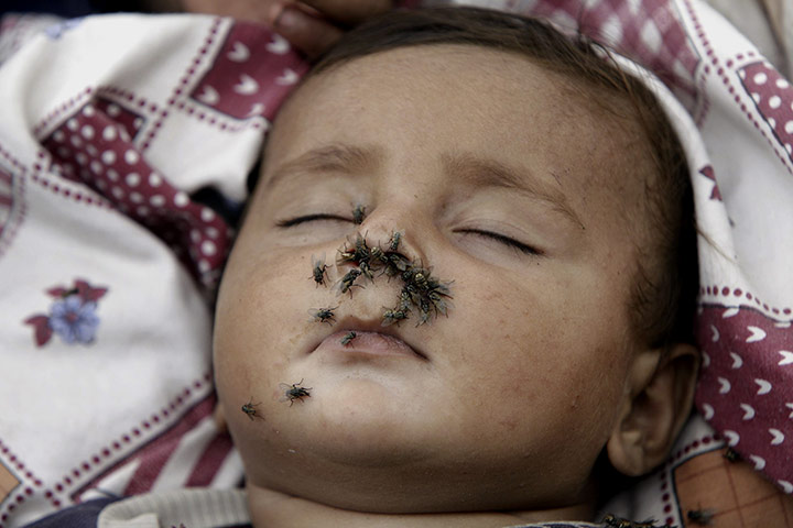 Pakistan flood survivors: A flood-affected child sleeps in his makeshift tent in Azakhel