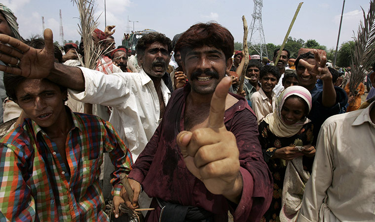 Pakistan flood survivors: Angry flood survivors gesture as they block a highway