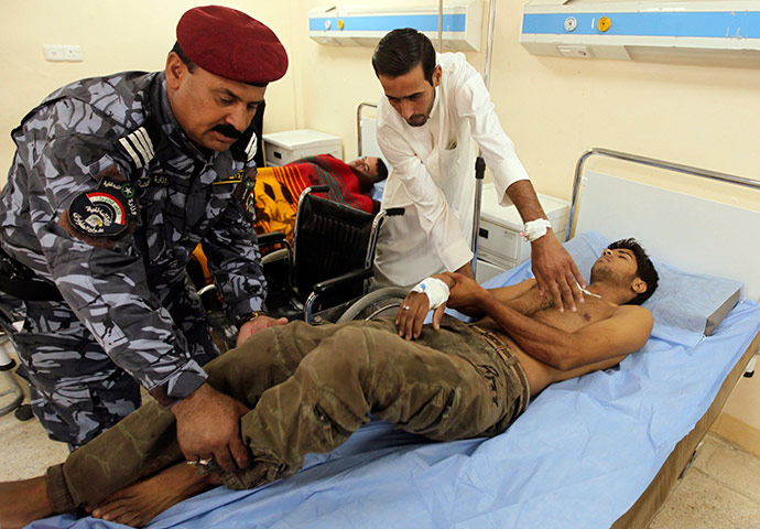 Baghdad bombing: A wounded army recruit is transferred to a hospital after a bomb, Baghdad