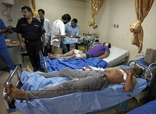Baghdad bombing: Victims of a suicide attack are tended at a hospital in Baghdad